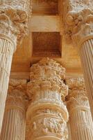 Stone columns rise. Old ornate architecture. Ancient building details. Carved decorations. Pillars hold ceiling. Tall textured stone structure. Ancient style. Architectural history in stone. photo