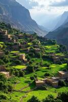 Mountain village view. Stone houses stand on lush green terraces. Valley scenery in the background. Peaceful landscape with mountains and clouds. photo