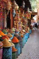 Spices at market. Many colorful piles. Shop of food in old town. Lanterns and ornaments for sale. Outdoor view of spice bazaar. photo