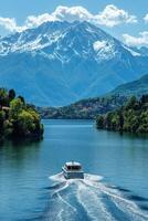Lake view with mountain. Boat travels on water. Landscape scene with green trees. Summer day with blue sky and white clouds. photo