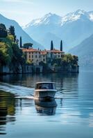 Boat sailing on lake water. Building stands on cliff. Mountains with snow in background. Sunny day. Water reflection. photo