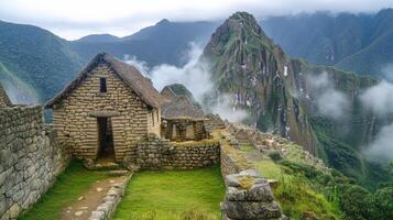 Ancient stone building with grass and mountain in background. Old architecture, nature, and travel. Scenic landscape on a cloudy day. photo