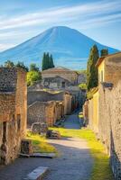 Old ruins street view. Mountain stands tall. Ancient stone buildings and blue sky. Walkway between walls. Light shines down. Travel scene. Summer day. photo