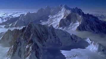 Snowy mountain peaks rise above clouds. Majestic mountains with snow and ice. Scenic landscape with high altitude summits. Beautiful cold weather scene. photo