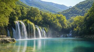 Waterfall flows into blue lake. Green trees and mountains rise up. Scenic nature landscape. Water cascades down. Peaceful and serene scenery. photo