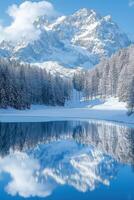Snow covered mountain reflected in lake water. Winter scene with trees and sky reflected. Cold landscape in daylight, beauty in nature. photo