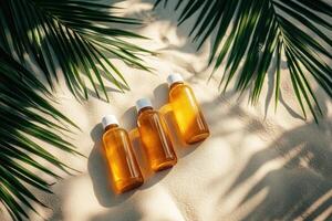 Sun tan lotion bottles on sand. Palm leaves create shadows. Summer vacation beauty concept. Warm sunny color. Golden liquid in clear bottles. photo