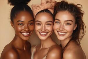 Three diverse young women smile together. Close up portrait of beautiful skin. Fresh natural makeup. Simple studio setting with soft light. photo