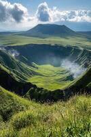 Green grassy volcano crater with steam inside on a sunny day. Beautiful open landscape with mountain view and blue sky. photo