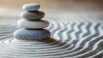 Balanced stones stand calmly on smooth sand. Zen garden shows relaxation with waves. Soft light and serene composition. photo