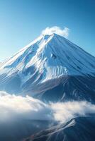 Snow covered mountain peak rises above clouds on a sunny day. Volcanic peak with snow. Beautiful mountain landscape. Clear blue sky above. photo