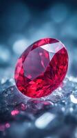 Sparkling red gem sits on cool icy stones. Shiny ruby with many facets in bright studio light. Blurred blue background completes scene. photo