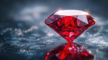 Large ruby gemstone rests on speckled surface. The red stone reflects light. Diamond cut with bright color and dark background. photo