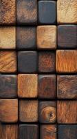 Arrangement of small brown wooden cubes shows textured wood surface. Dark blocks form repeating square pattern. Close up of solid wood background. photo