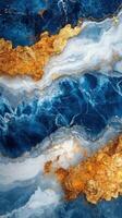 Abstract art with blue and white liquid texture and gold paint. Waves swirl and create unique patterns. Paint runs freely in this background. photo