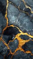 Dark stone surface with golden veins. Abstract background showing a natural stone pattern. Decorative wallpaper featuring streaks of shiny color. photo