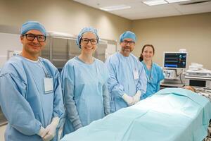 Medical professionals stand in operating room. Surgical team ready near patient on operating table. Modern hospital setting with equipment and monitor. photo