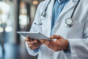 Medical professional in white coat holds a tablet. Doctor using digital device. Person wearing stethoscope in hospital. Healthcare professional with technology indoors. photo