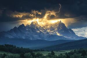 Mountain range under dark clouds. Golden light shining through. Lightning strike. Forest in foreground. Dramatic sky. Mountain peaks. photo