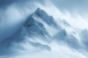 Snowy mountain peak surrounded by blowing snow and mist. Winter scene of a high mountain with jagged edges covered in ice and snow. photo