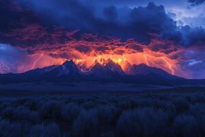 Dramatic lightning strikes behind mountain range. Intense storm with dark clouds and orange glow. Field of shrubs in foreground. Dark blue and orange colors. photo