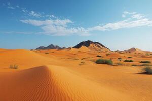 Desert landscape with sand dunes and distant rocky mountains under a clear blue sky with scattered clouds. Sand textures and dry bushes visible. photo