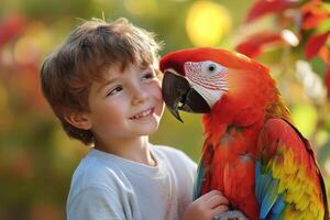Young boy smiling at a colorful macaw parrot. Child gently touches the bird. Blurred outdoor nature background. Friendship between people and animals. photo