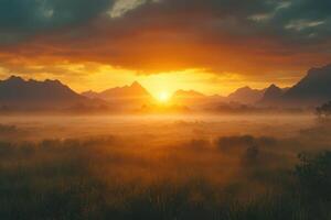 Golden sunrise over foggy valley. Mountains silhouette against bright sky. Grass field bathed in warm light. Peaceful landscape scene with dramatic clouds. photo