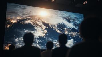 People watching a movie on a large screen photo