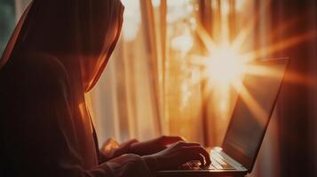 Beautiful muslim student girl using a laptop computer learning photo