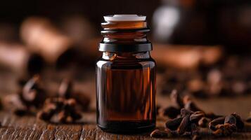 A bottle of essential oil on a wooden table. photo