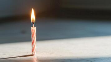 A single lit candle on a table photo
