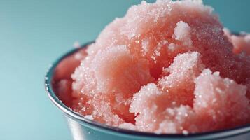 A close up of a cup filled with pink sugar photo