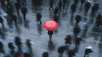 A person with a red umbrella walking in a crowd photo