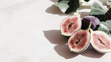 Figs on a white surface with leaves photo