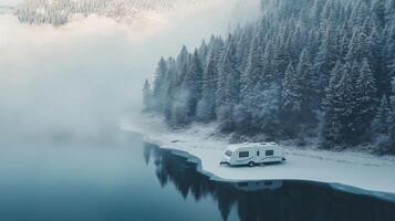 Winter serenity with caravan on a frozen lake in a snow covered forest photo