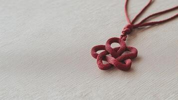 A red necklace with a knot on it photo