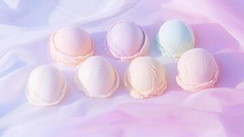 Five pastel colored eggs on a pink and blue cloth photo