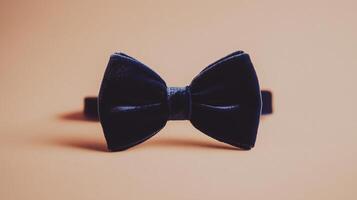 A black bow tie on a tan background photo