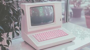 An old computer with pink keys sitting on a table photo