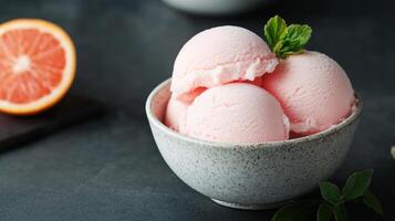Refreshing Orange Sherbet Scoops in a Bowl photo
