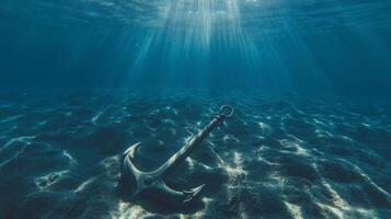 An anchor in the ocean with sunlight shining through photo