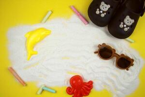 Sand background with chalk, sand molds and accessories for a summer day. Bright background for the concept of beach, summer and tourism. photo