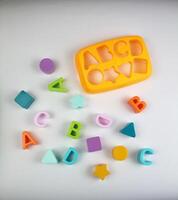 Sorter game with letters and figures. Concept of training. photo