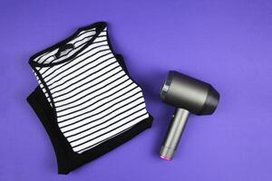 Concept of care and concern for clothes.Pill machine lies on a purple background. Top view. photo