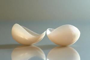 Chicken fillets enhancing breast shape lying on reflective surface photo