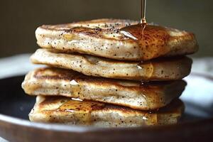 Stack of pancakes dripping with maple syrup for a delicious breakfast photo
