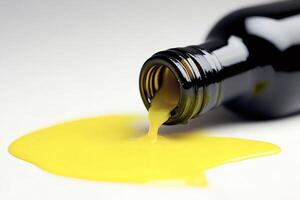 Yellow liquid pouring from a black bottle creating a puddle photo