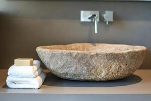 Stone sink enhancing modern bathroom design with natural aesthetics photo