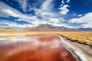 Red lagoon reflecting cloudy sky with mountains in the background photo